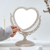 Our Cottagecore Vintage Style Heart Shaped Mirror is Intricately crafted with ornate floral and scrollwork detailing, giving the perfect, timeless cottagecore aesthetic. The silhouette adds a romantic touch to any vanity, bedroom, or entryway. 
The mirror is double sided with a magnifying area for detailed makeup application on one, making it a great addition to your beauty routine. An elegant but hip piece for many styles!